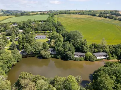 an aerial view of a house next to a river at 2 Streamside in Looe