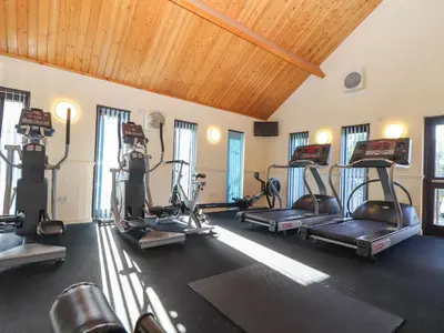a gym with several treadmills and exercise bikes at Adelaide in Redruth