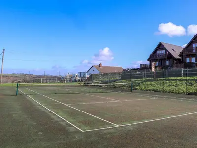 a tennis court with a net on top of it at Adelaide in Redruth