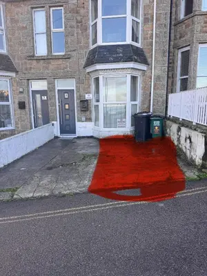 a red rug in front of a building at Heart of St Ives with parking - 2 bedrooms in St Ives