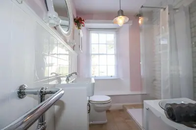 a bathroom with a white toilet and a sink at Rosedale in St Ives