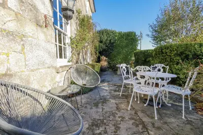 a group of chairs and tables in a garden at Rosedale in St Ives