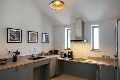 a kitchen with a sink and a counter top at Lowenna at Cusgarne Manor, rural, accessible in Cusgarne