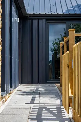 an open door of a building with a metal roof at Lowenna at Cusgarne Manor, rural, accessible in Cusgarne