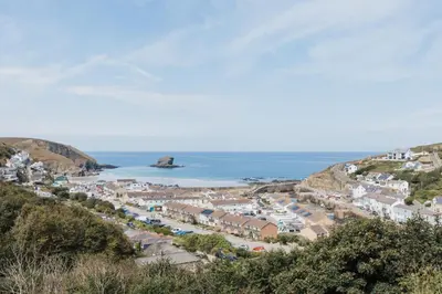 a coastal town with houses and the ocean at Tamarisk in Portreath