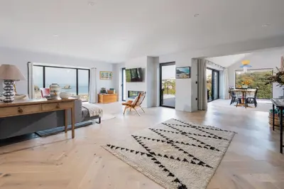 an open living room with a table and a desk at Tamarisk in Portreath