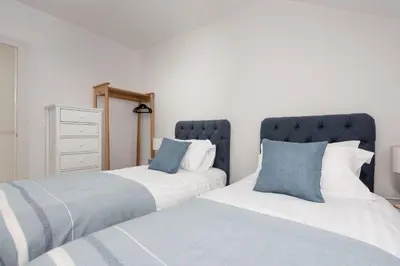 two beds sitting next to each other in a bedroom at Watergate View in Porth