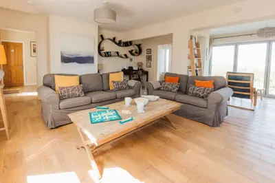 a living room with a couch and a coffee table at Trewalder in St Merryn