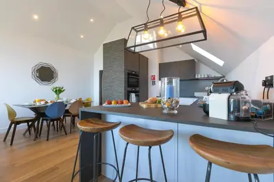 a kitchen with a counter and stools in a room at Sea Vista in Carbis Bay