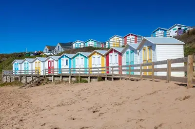 a row of colorful houses on a beach at 1 Bed in St. Gennys oc-l34629 in Crackington Haven