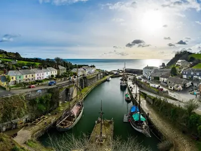 a group of boats are docked in a river at Little Sea View Duporth - 3 bed, gated beach, Nr Eden Project in Charlestown