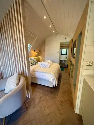 a bedroom with a large bed and a tub in it at The Secret Garden Glamping Cornwall in Cury