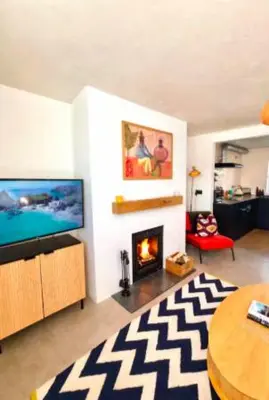 a living room with a television and a fireplace at The Palms Cottage Exclusive Use 3 Bedroom Parking Central Newquay in Newquay