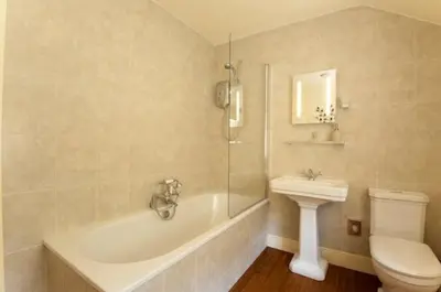 a bathroom with a tub and a toilet and a sink at Holly in Kea