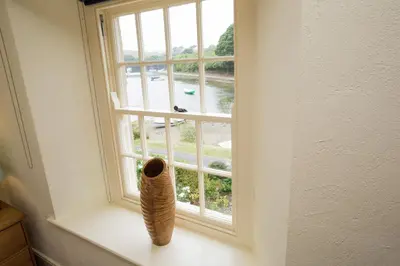 a window with a vase sitting on a window sill at Holly in Kea