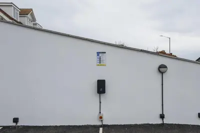a large white building with a sign on the side at Modern Groundfloor Apartment with Private Parking in Newquay