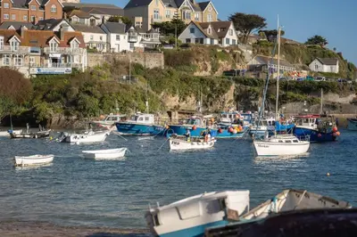 a group of boats docked in a harbor with houses at Stylish Apartment Sea Views Central Newquay in Newquay