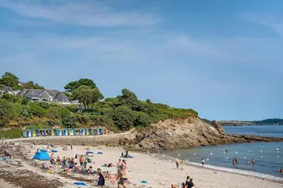 a group of people on a beach near the water at Modern Townhouse in Central Falmouth Nr Seafront in Falmouth