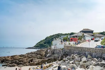 a group of people standing on a beach near the water at Modern Townhouse in Central Falmouth Nr Seafront in Falmouth
