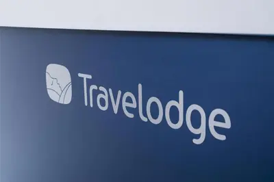 a sign for a travel loadage company on a wall at Travelodge Wadebridge in Wadebridge