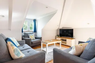 a living room with two couches and a tv at Spacious Flat A Few Mins Walk to Carlyon Bay Beach in Carlyon Bay