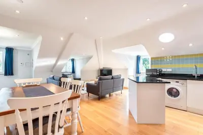 a kitchen and living room with a table and a dining room at Spacious Flat A Few Mins Walk to Carlyon Bay Beach in Carlyon Bay