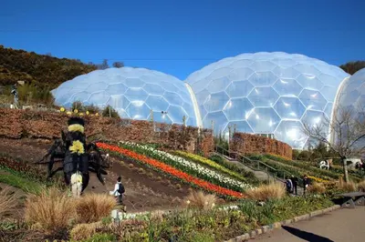 a group of domes in a garden with flowers at Tinners Forge a pretty cottage near Mevagissey in St Austell