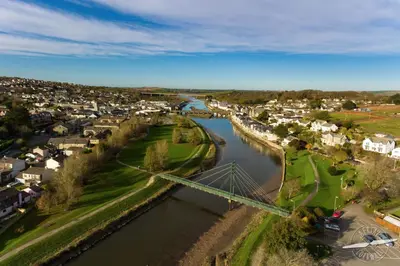 an aerial view of a town with a river at Fernleigh Cottage near the North Cornish beaches in Saint Mabyn