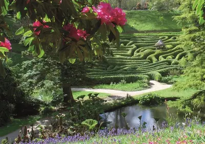 a garden with a maze and a pond at Thumbelina far reaching views of the countryside in Budock Water