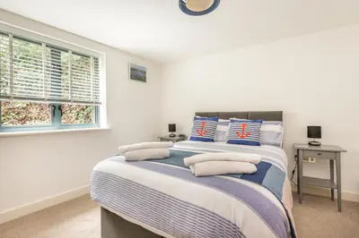 a bedroom with a bed with pillows on it at Zephyr in Fowey