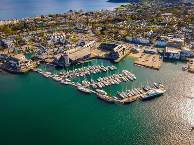 an aerial view of a harbor with boats in the water at 1 Arvor – Two-Bedroom Apartment with Parking at Maenporth Beach! Cornwall in Falmouth
