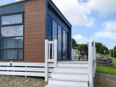 a tiny house with a wooden door and stairs at Valley View - Uk50320 in Liskeard