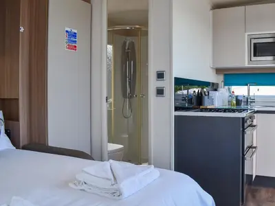 a room with a kitchen and a bed with towels at Valley View - Uk50320 in Liskeard