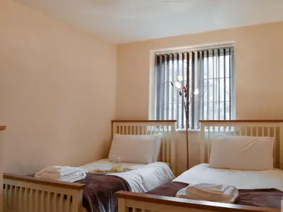 a small room with two beds and a window at Henhouse - Uk49016 in Liskeard