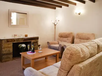 a living room with a couch and a fireplace at Haybarn - Uk49019 in Liskeard