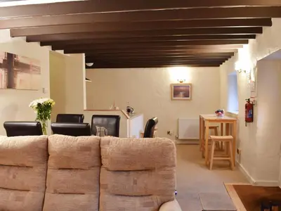 a living room with a couch and a table at Haybarn - Uk49019 in Liskeard