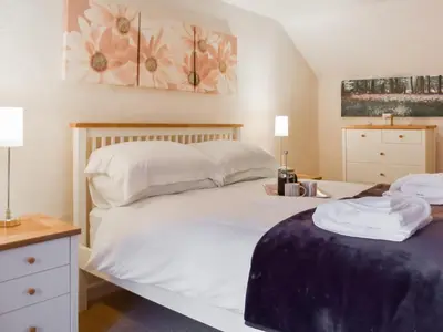 a bedroom with a bed with white sheets and pillows at Haybarn - Uk49019 in Liskeard