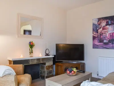 a living room with a tv and a fireplace at Milking Parlour - Uk49026 in Liskeard