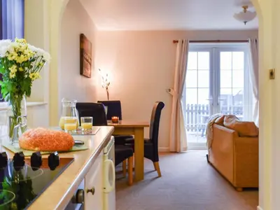 a kitchen and living room with a table and a dining room at Milking Parlour - Uk49026 in Liskeard