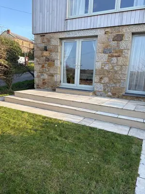 a stone house with a patio and a window at Porthtowan Guest Suite in Porthtowan
