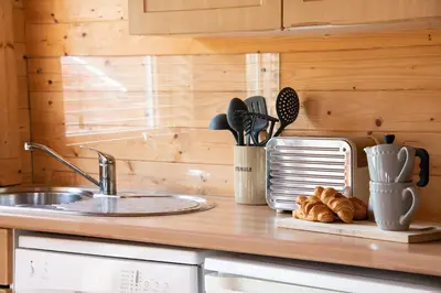 a kitchen counter with a sink and some croissants at The Cabin at Little Bosveal near the Helford River....lovely location in Mawnan Smith