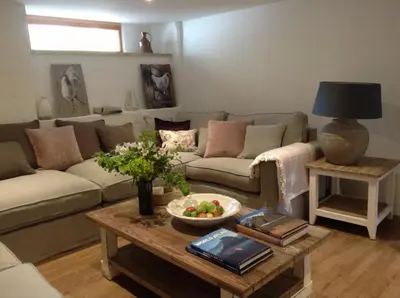 a living room with a couch and a table at The Vineyard in Fowey