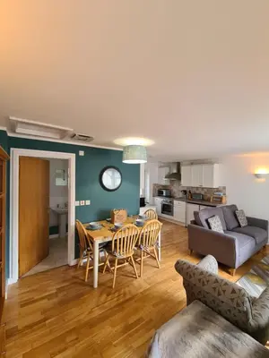 a living room with a table and a couch at Inny Glade in Davidstow
