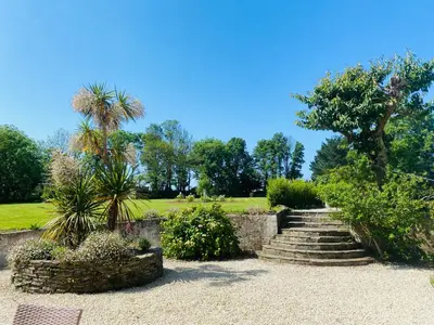 a set of stairs in a garden with trees at Jacobean Farmhouse, sleep 10 guests, pet friendly in Saint Mawes