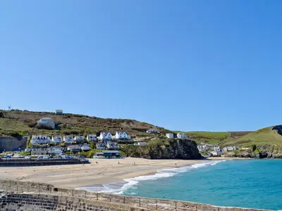 a view of a beach with houses and the ocean at Ash in Scorrier