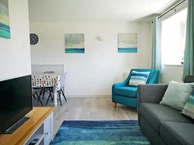 a living room with a couch and a tv at Elm - 31304 in Porthtowan