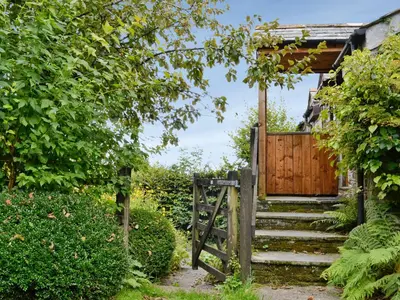 a set of stairs leading to a wooden gate at Tucked Away in Linkinhorne