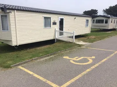 a parking lot in front of a mobile home at Newquay Bay Holiday Resort in Newquay