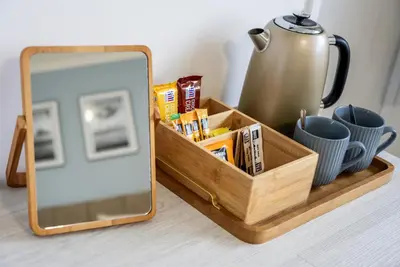 a wooden tray with a mirror and a tea kettle at The Inn For All Seasons in Redruth