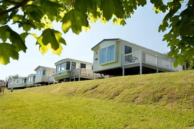 a row of houses on top of a hill at Widemouth Bay Caravan Park in Bude
